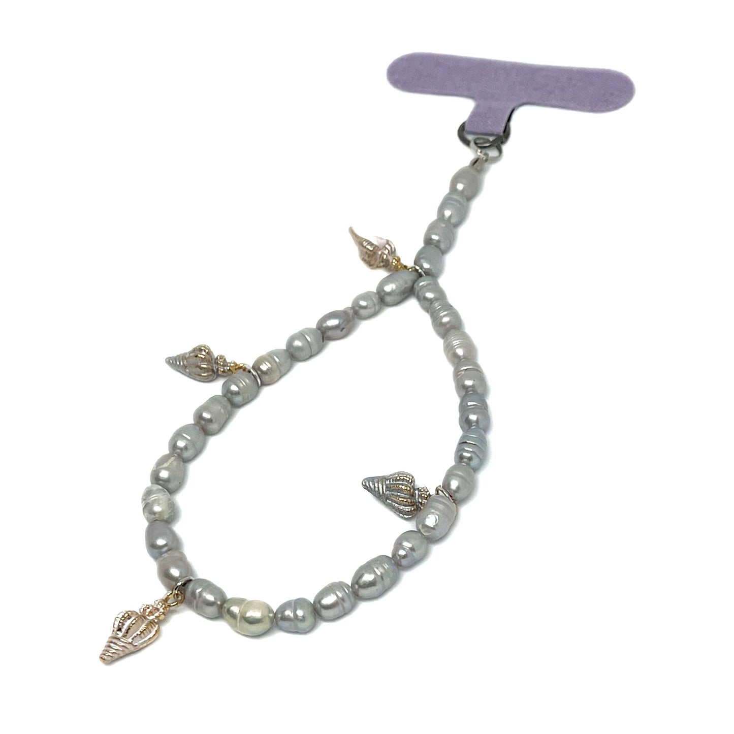 Front right view of a Genuine Lombok Freshwater Pearl Phone Strap. An Elegant Silver Handmade Wristlet with 4 decorative silver shells.