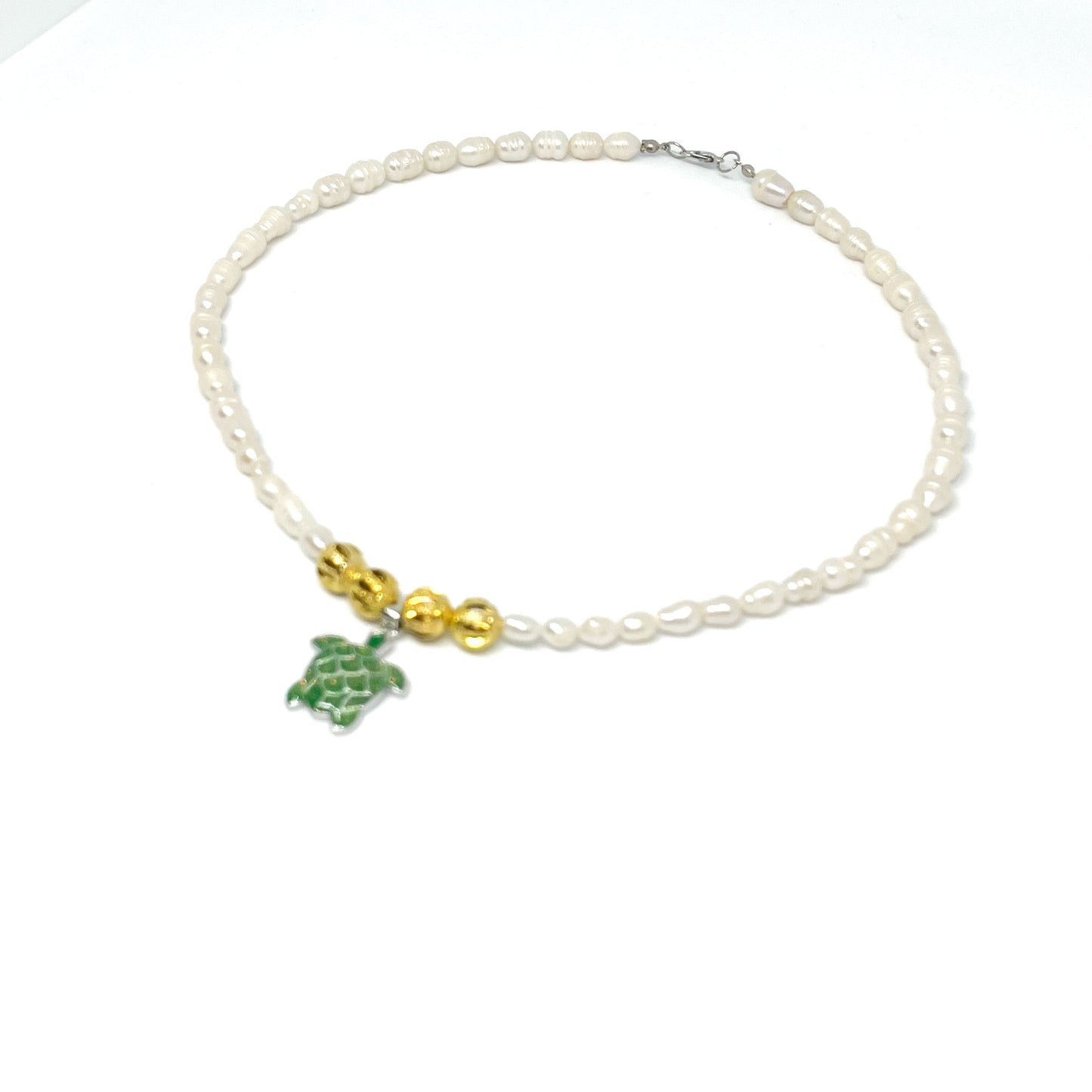 Fron right view of a Genuine Baroque White Freshwater Pearl Necklace with a Green Sea Turtle pendant