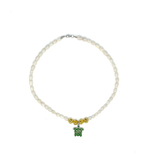 Genuine Baroque White Freshwater Pearl Necklace with a Green Sea Turtle pendant viewed from above.