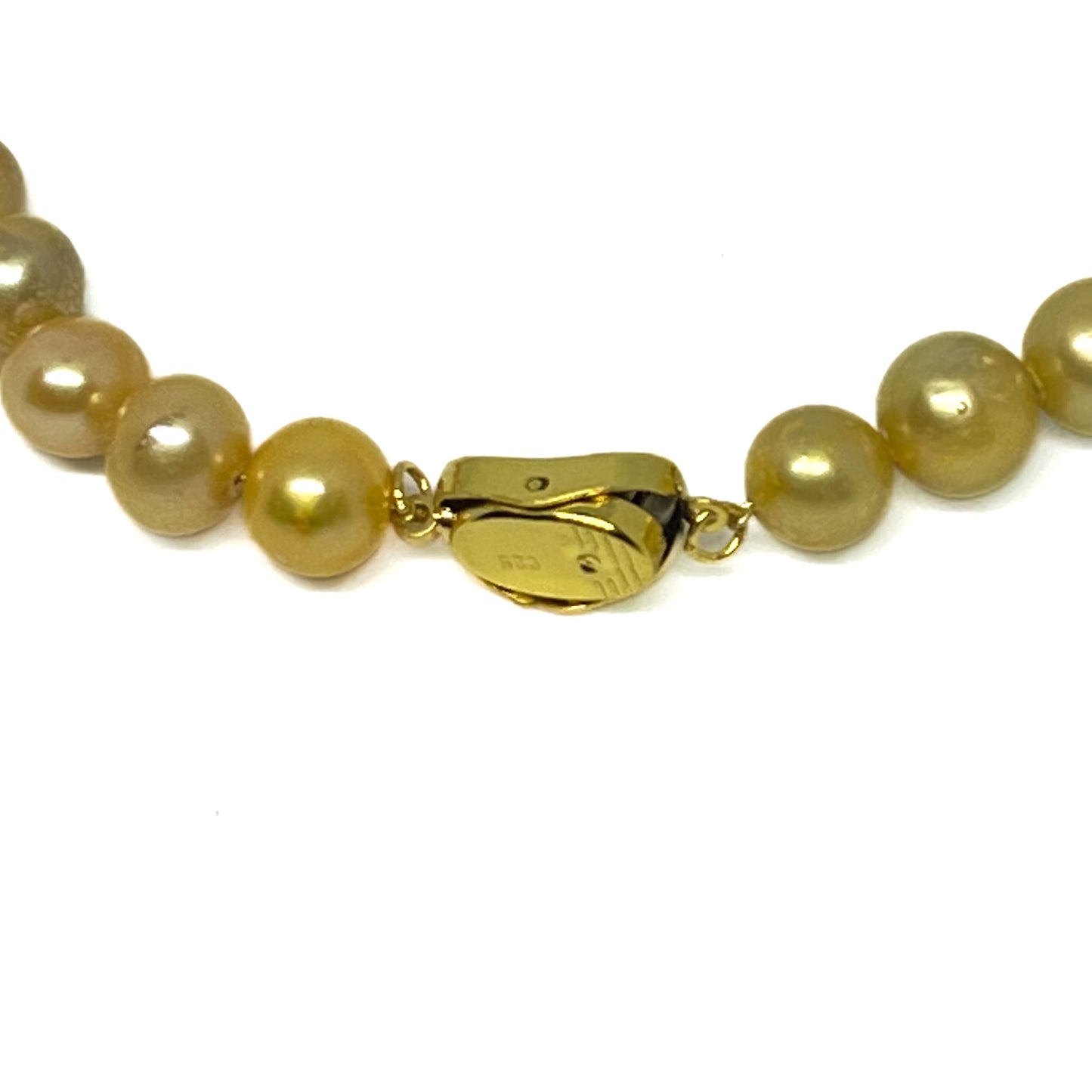 Close up of Gold Clasp on Gold Pearl Necklace.